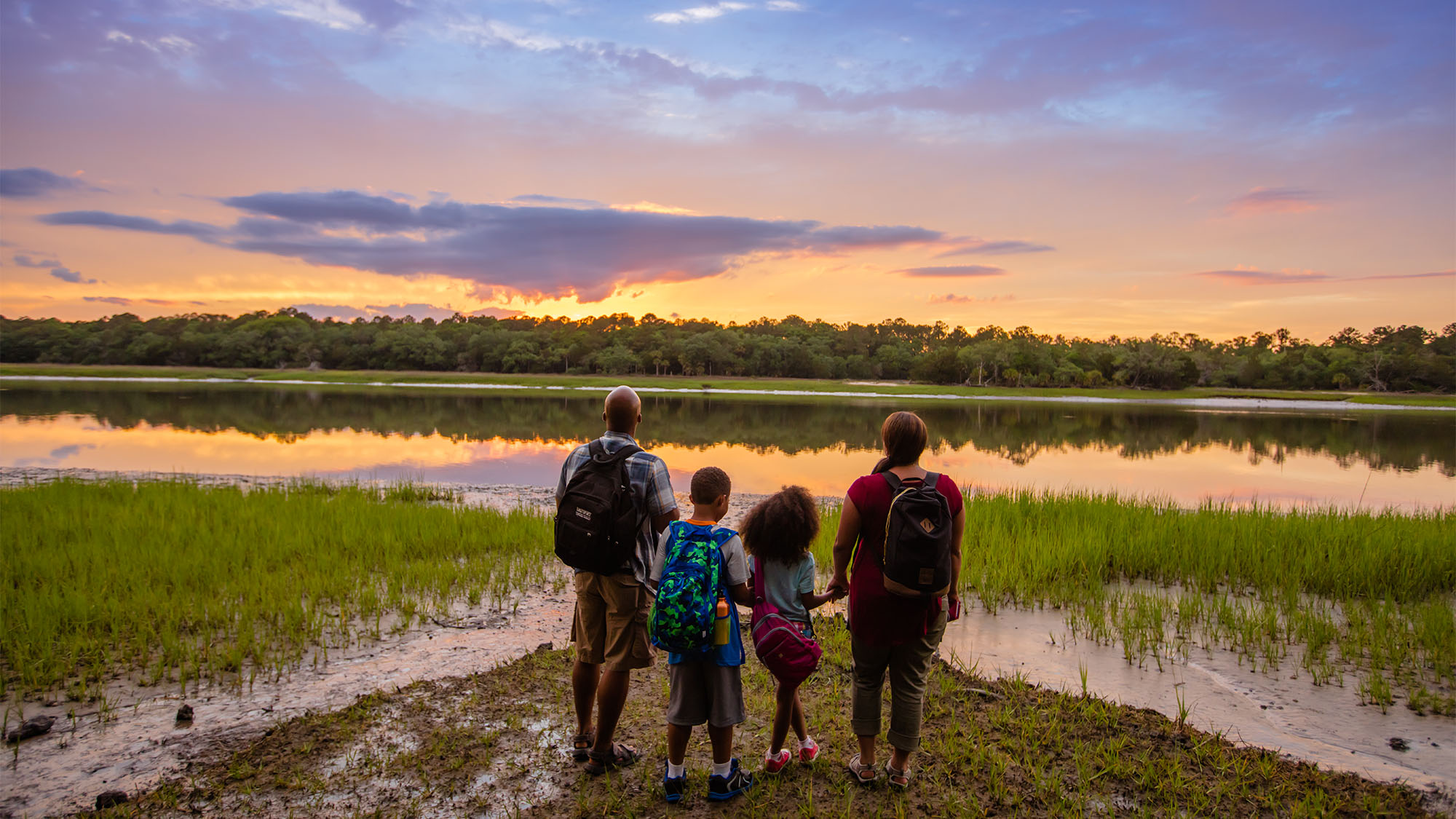 Family gazing at sunset at Skidaway Island State Park in Savannah, Georgia