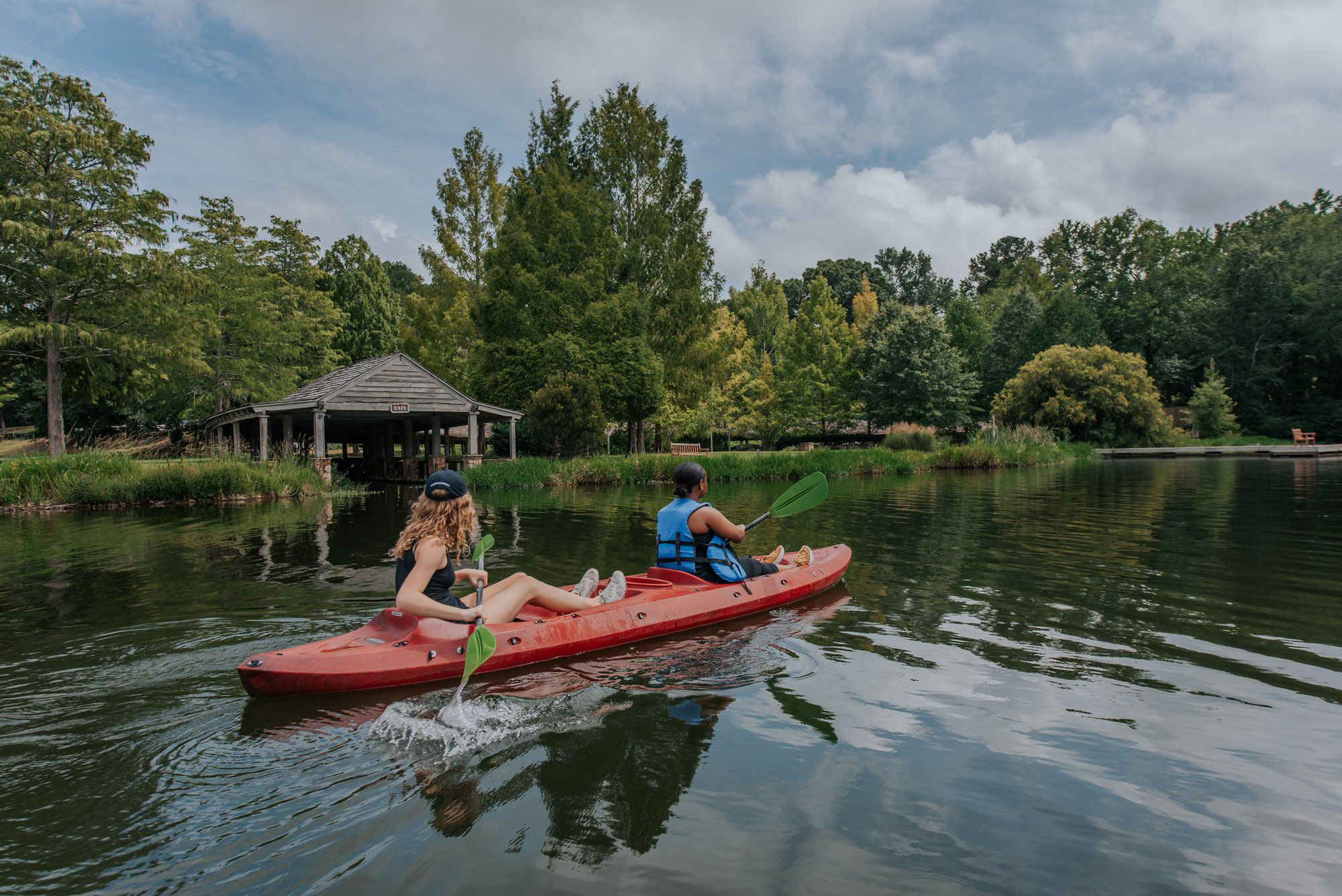Two women kayaking on a lake at Callaway Resort & Gardens in Pine Mountain, Georgia