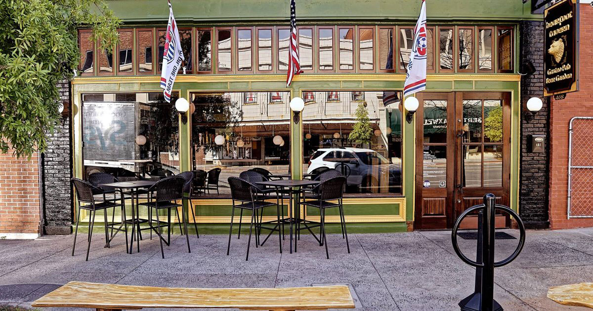 Exterior of Bearfoot Tavern with sidewalk tables in Macon, Georgia