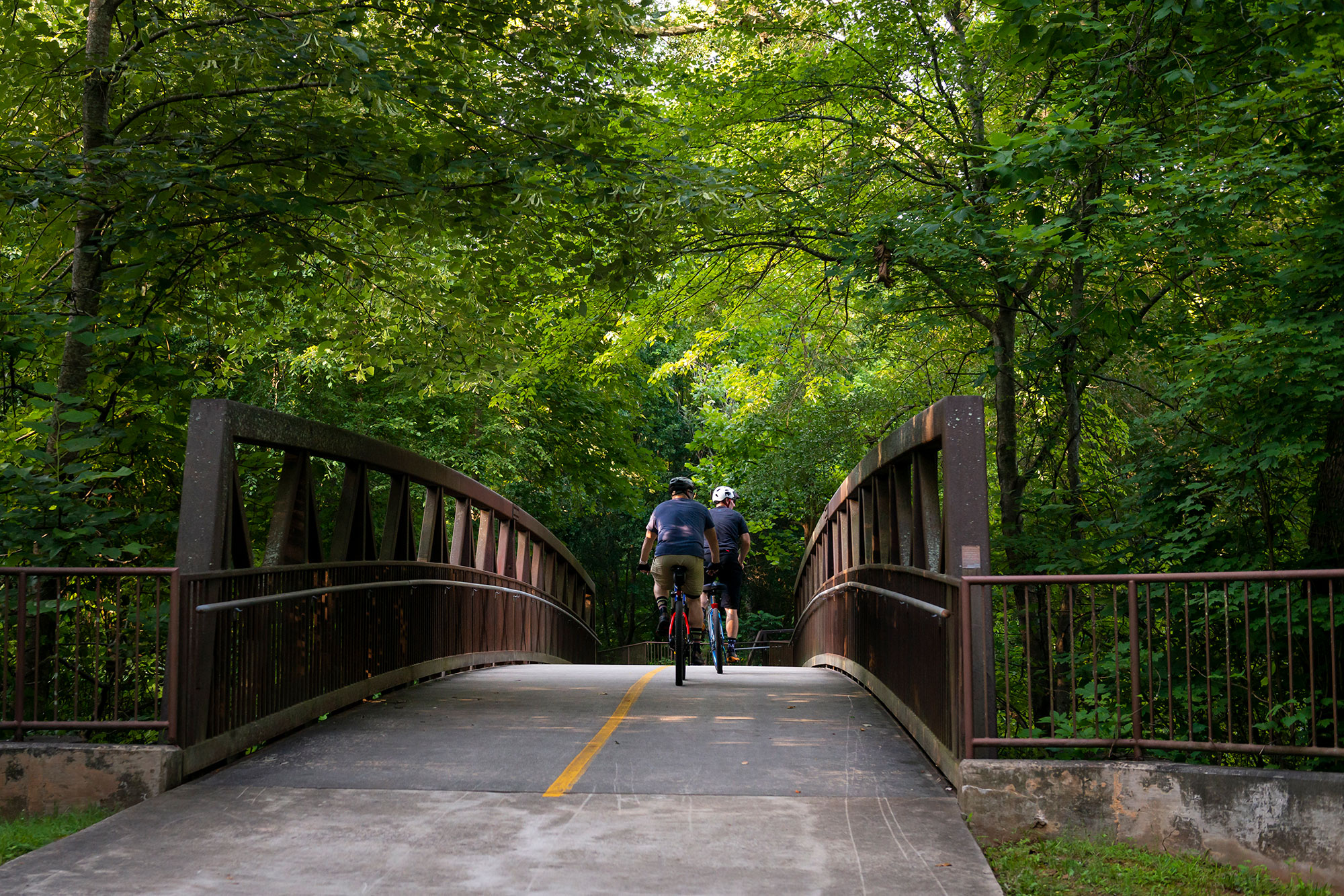 Cyclists crossing a bridge on the Big Creek Greenway in Alpharetta, Georgia