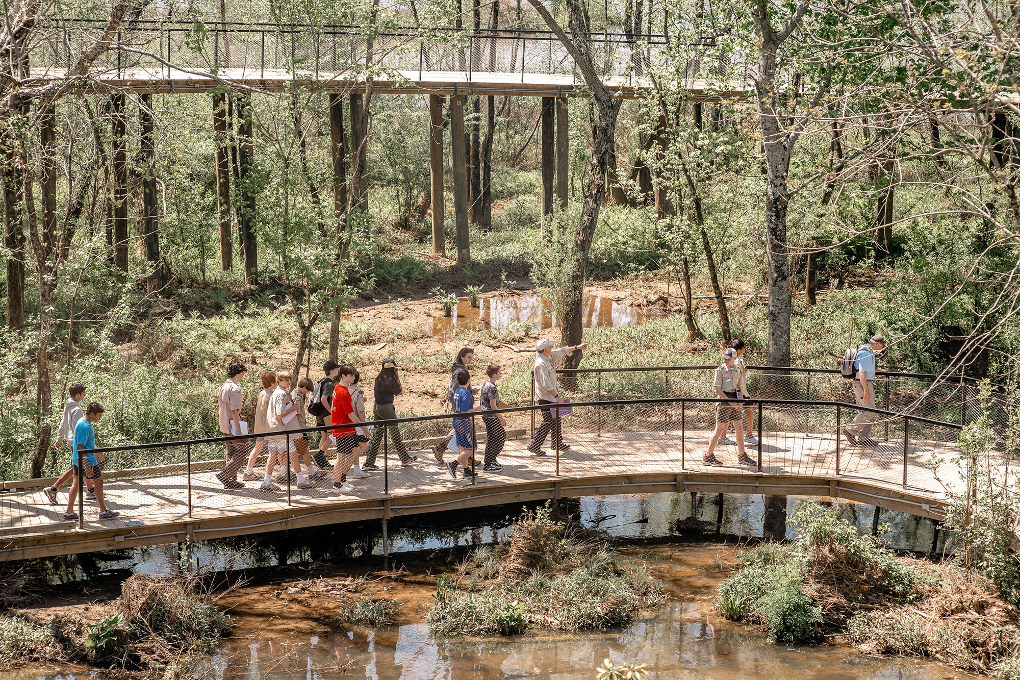 Aerial view of visitors walking on a boardwalk through wetlands at Chattahoochee Nature Center in Roswell, Georgia