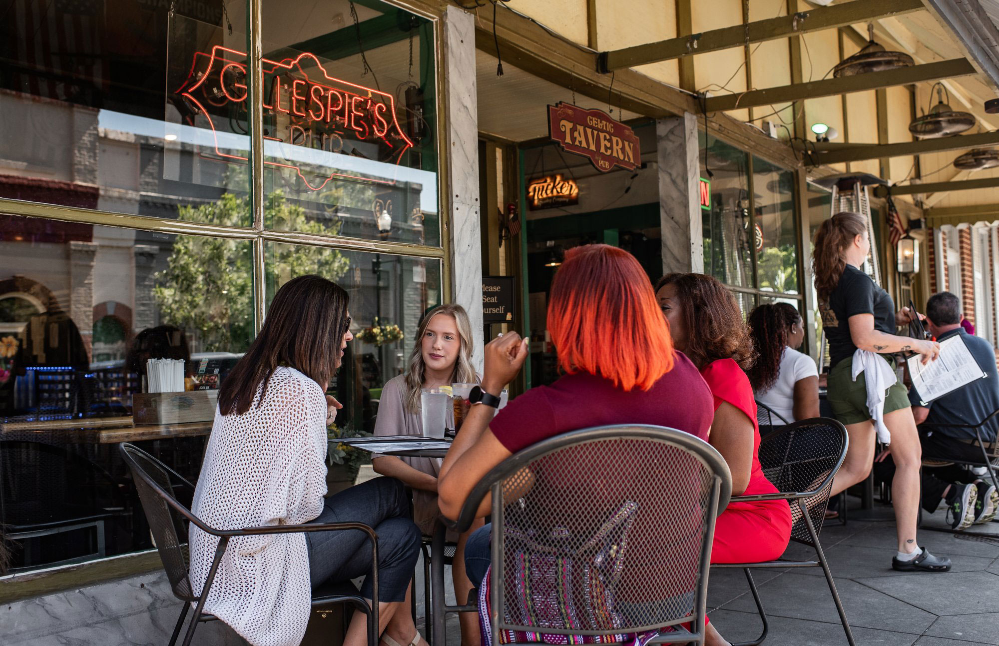 People dining at tables outside the Celtic Tavern