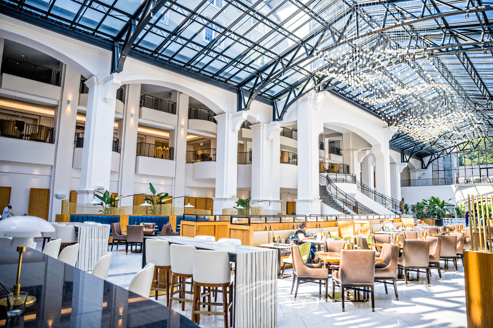 Airy inside view of the Chateau Elan Versailles restaurant and bar with soaring glass atrium of the Chateau.