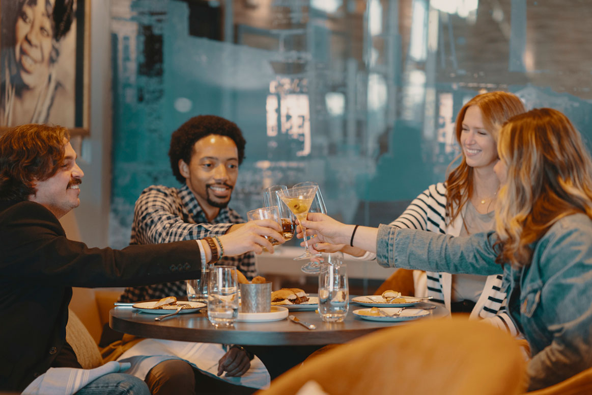 Group of friends having cocktails at Hotel Indigo in Columbus, Georgia