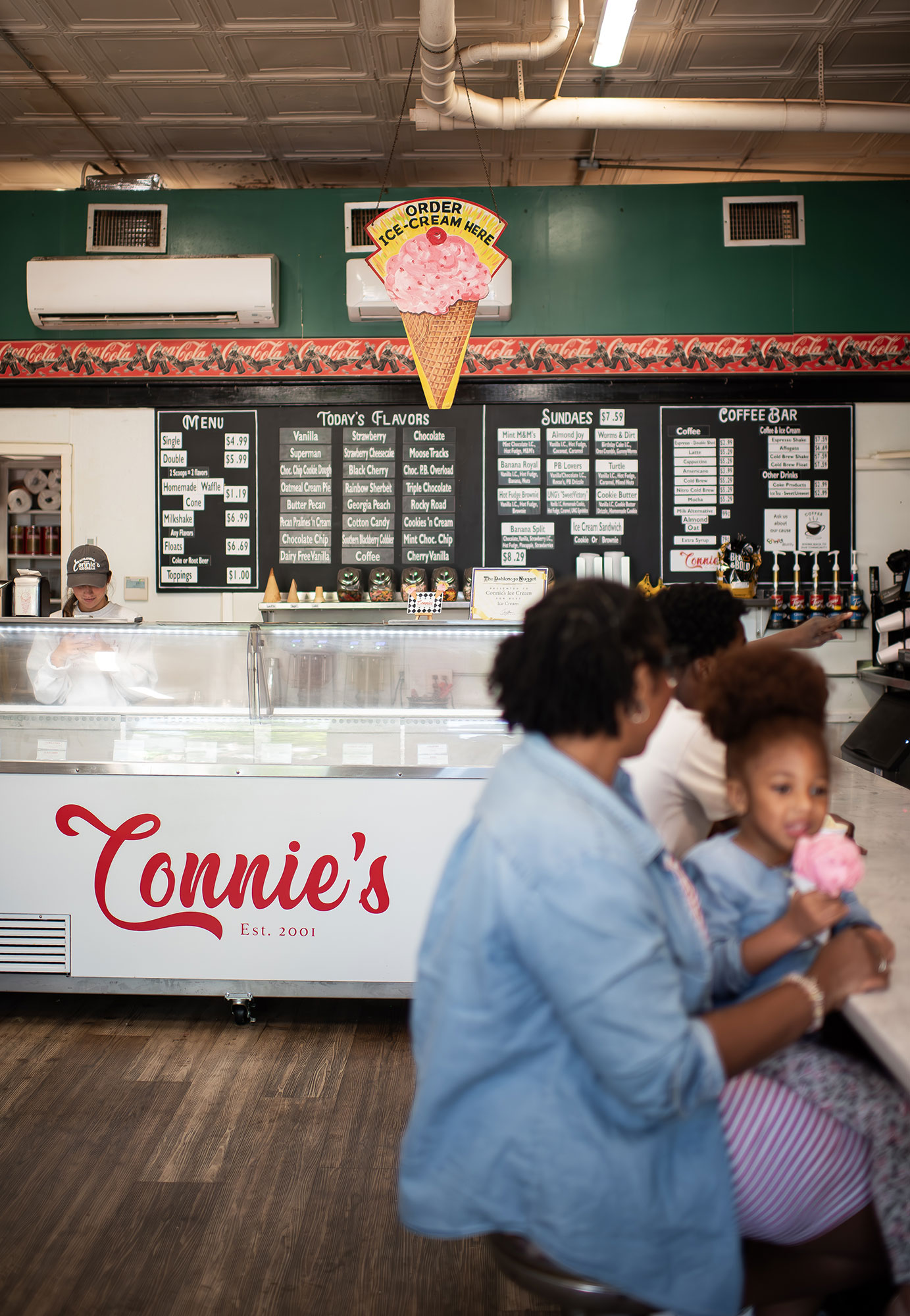 Family eating ice cream inside Connie's Ice Cream Parlor in Dahlonega, Georgia