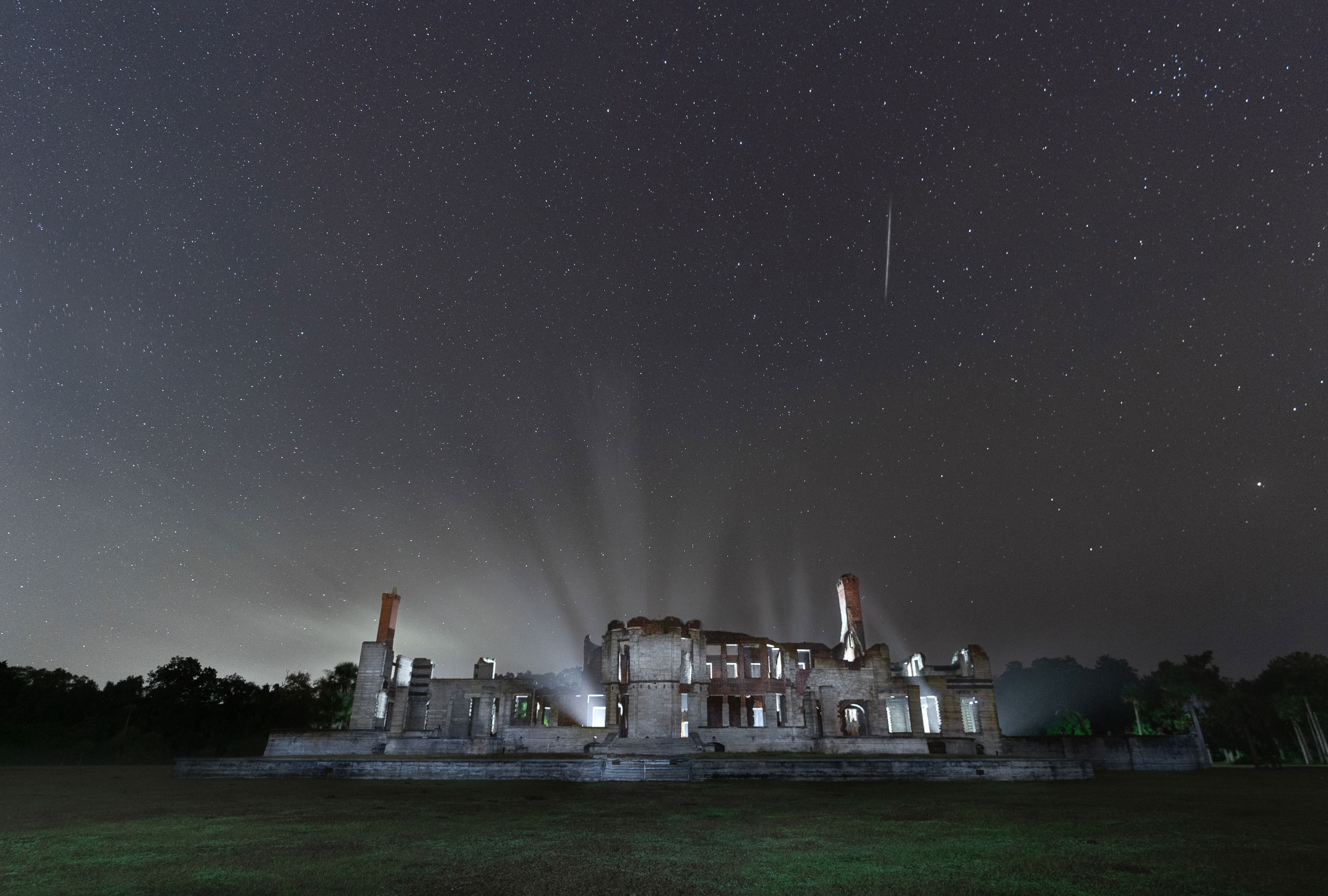 Dungeness Ruins on Cumberland Island dramatically lit at night with a starry sky. Photo by Chris Greer