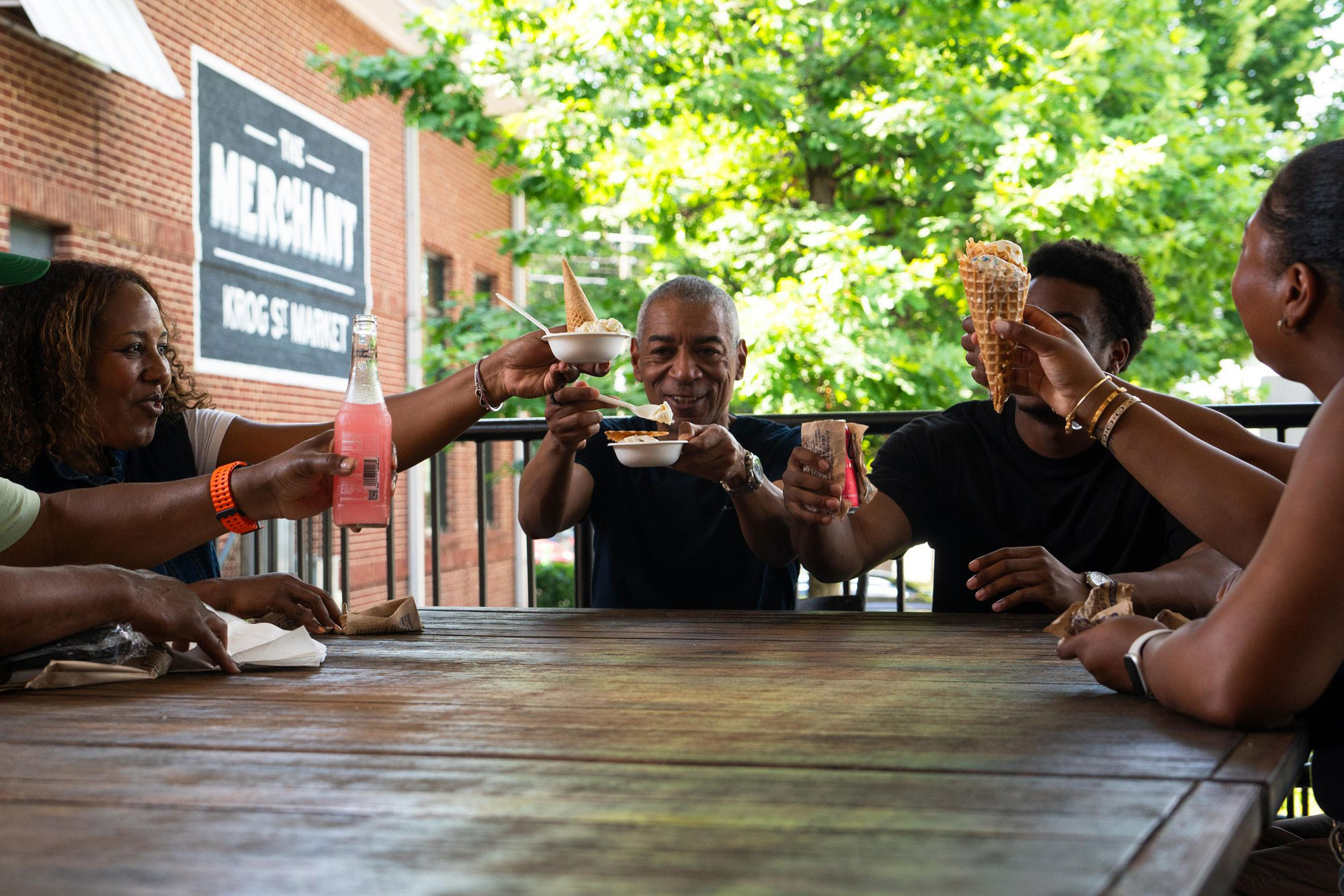 Family enjoying ice cream at a table at Krog Street Market in Atlanta, Georgia