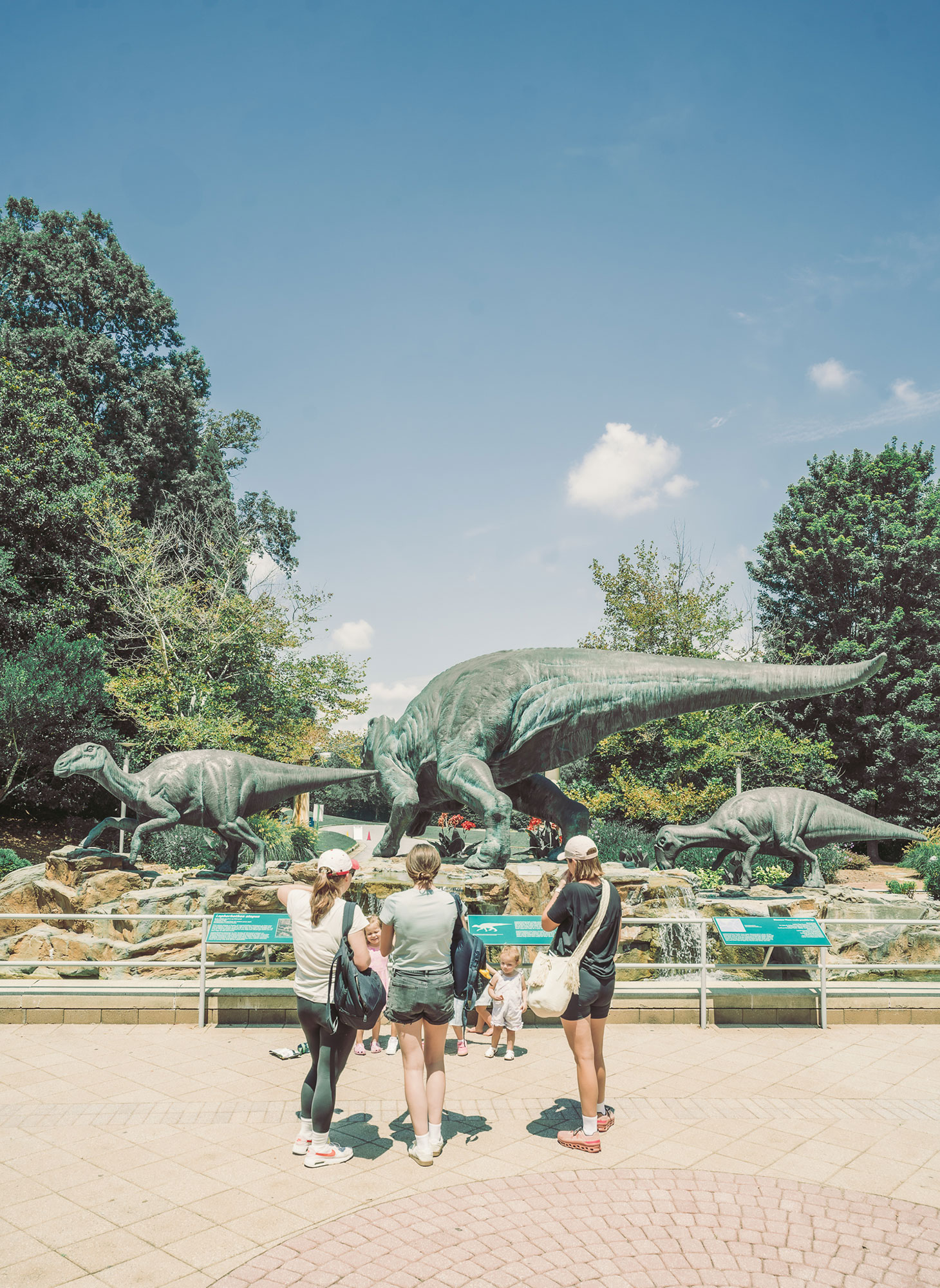 Family outside Fernbank Museum looking at the dinosaur statues