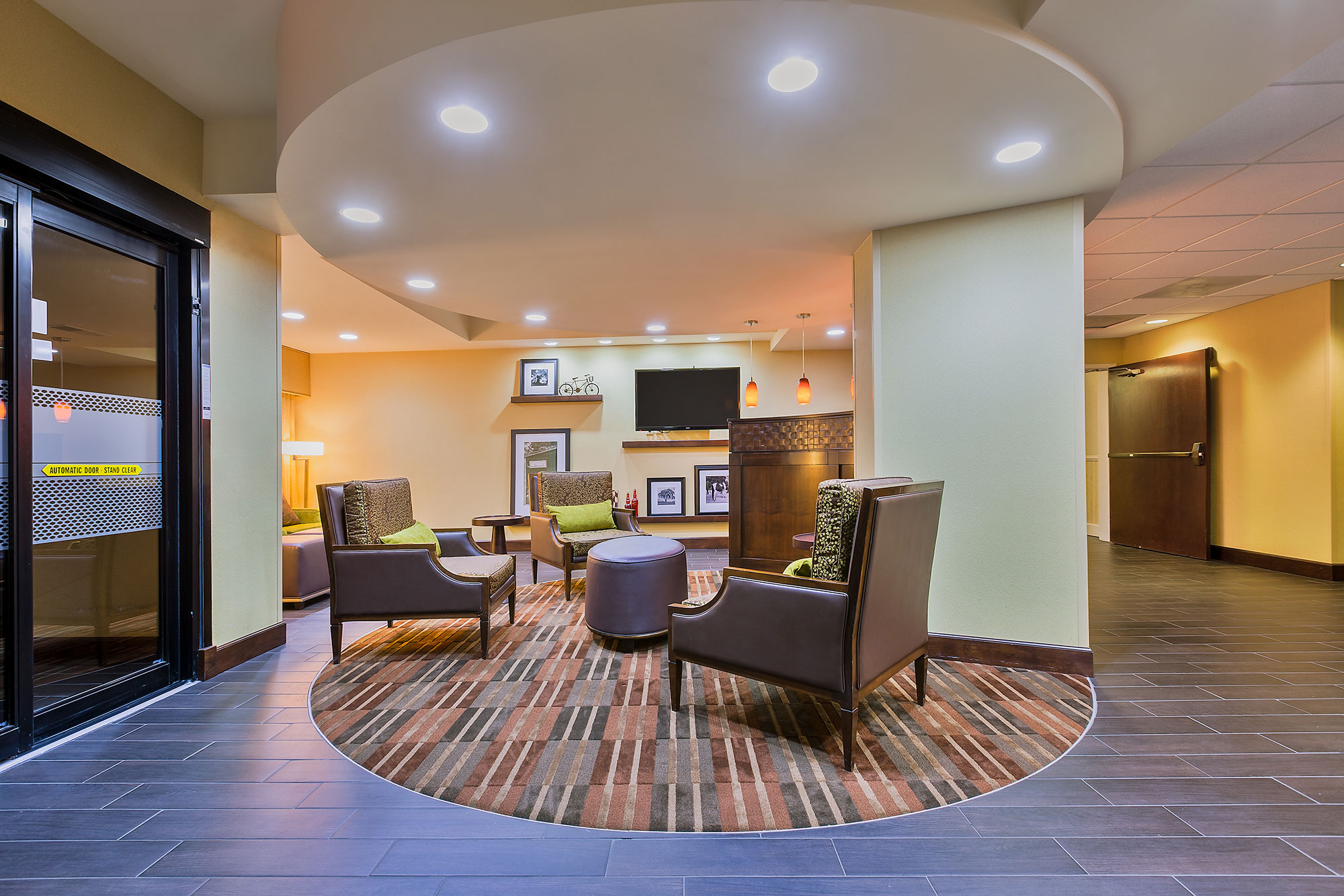 Multicolor carpet and seating inside the Hampton Inn Conyers lobby
