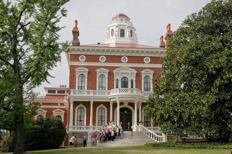 Group taking photo on stairs of Hay House in Macon, Georgia