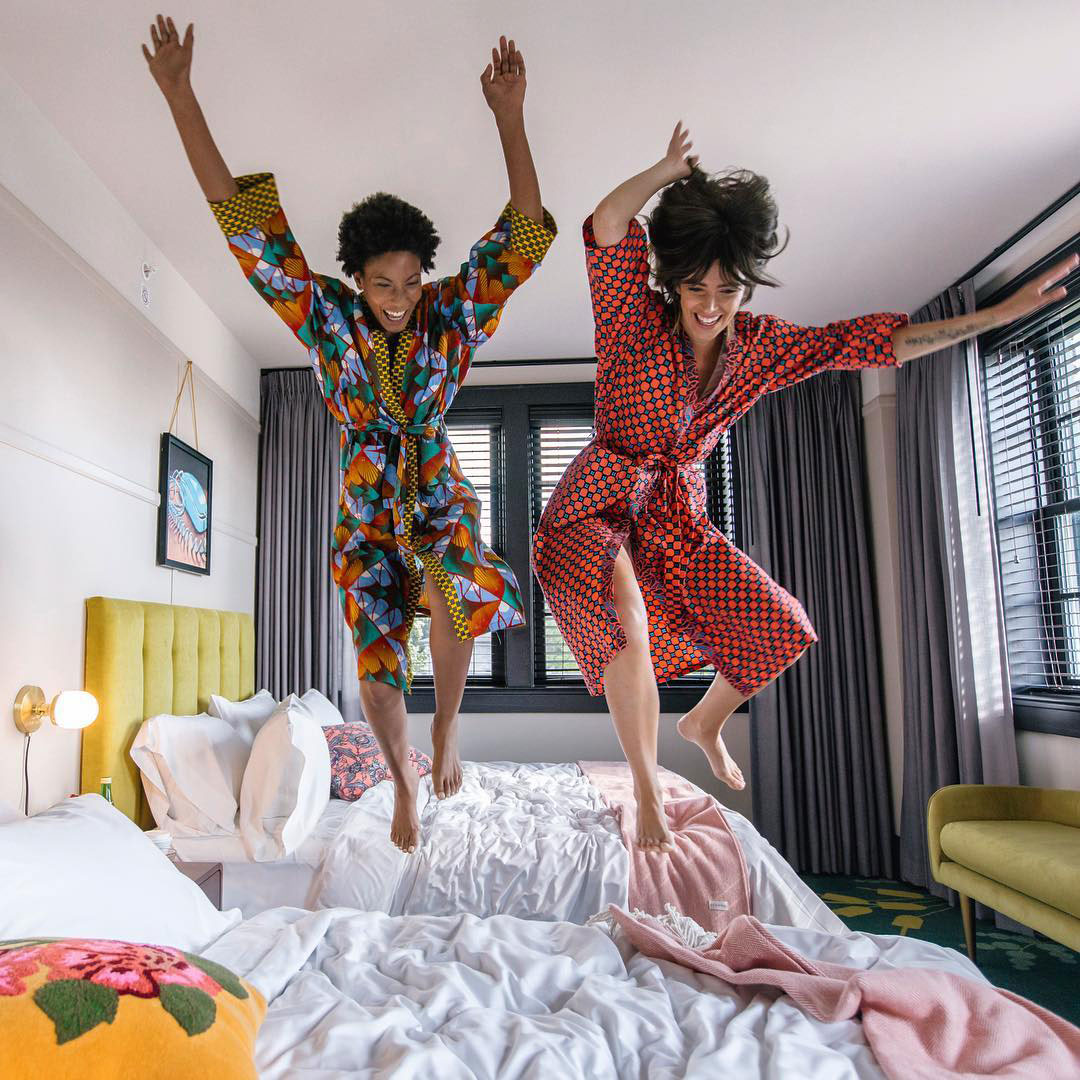 Women jumping on beds at the Hotel Clermont in Atlanta. Photo credit Hotel Clermont