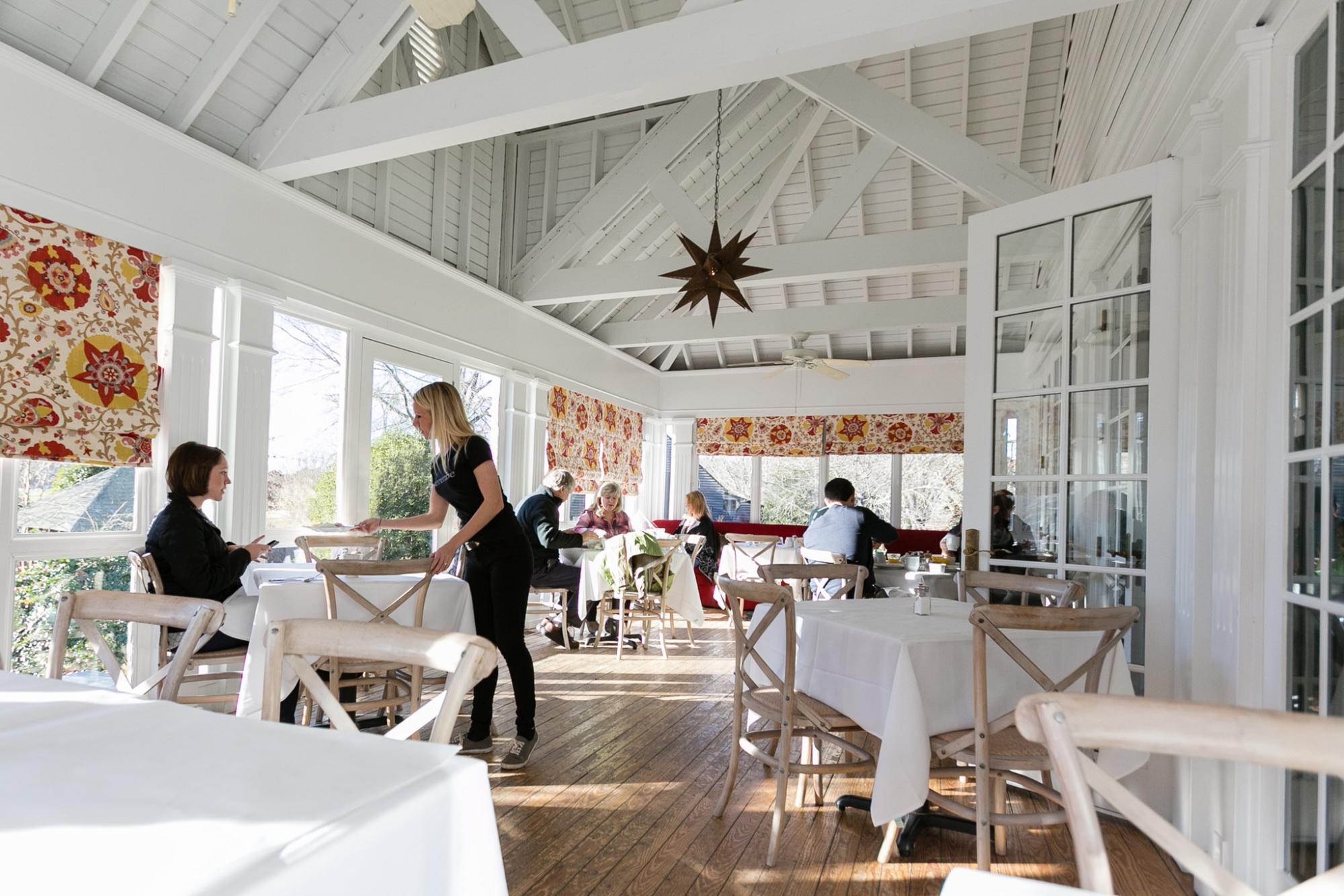 People dining on the patio at The Farmhouse at Serenbe