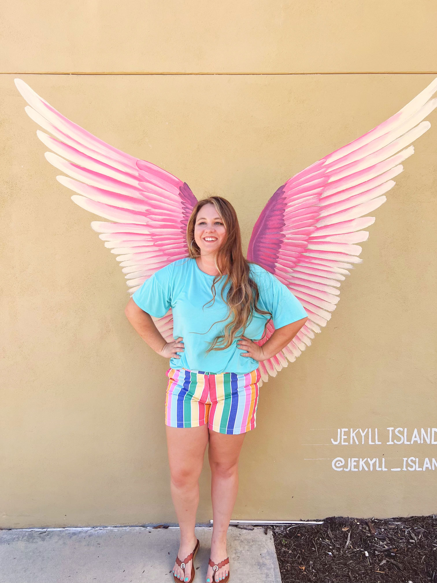 Woman in front of the wings mural on Jekyll Island, Georgia