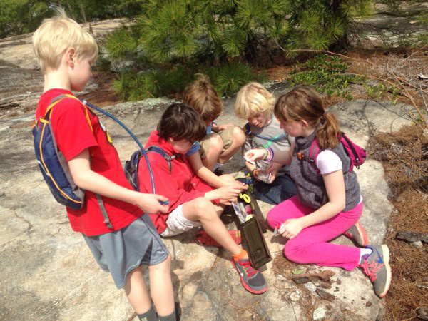 Children finding a geocache at Arabia Mountain National Heritage Area in Lithonia, Georgia