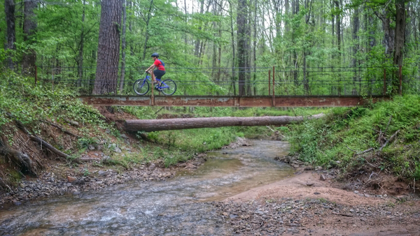 Biking through Cochran Mill Park. Photo by Candy Cook.