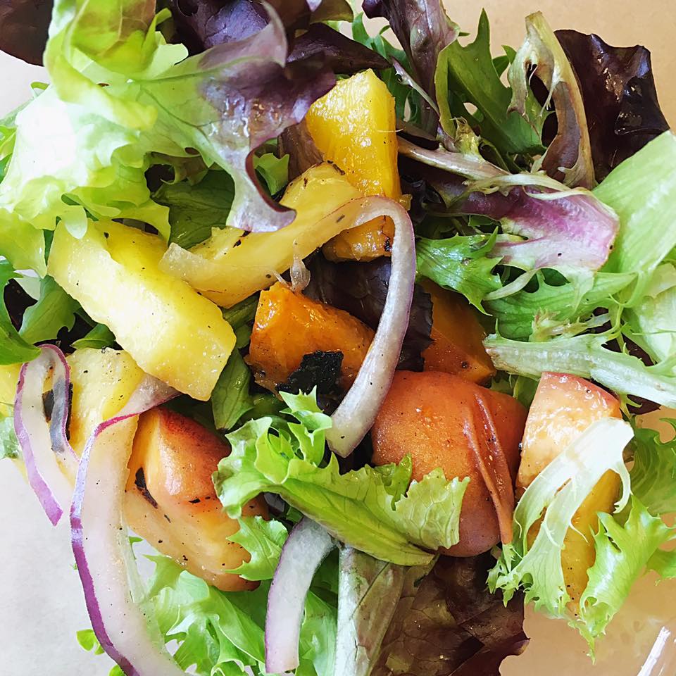 Spring greens & grilled apricots, pineapple & peaches at Farm to Ladle. - Photo: Facebook