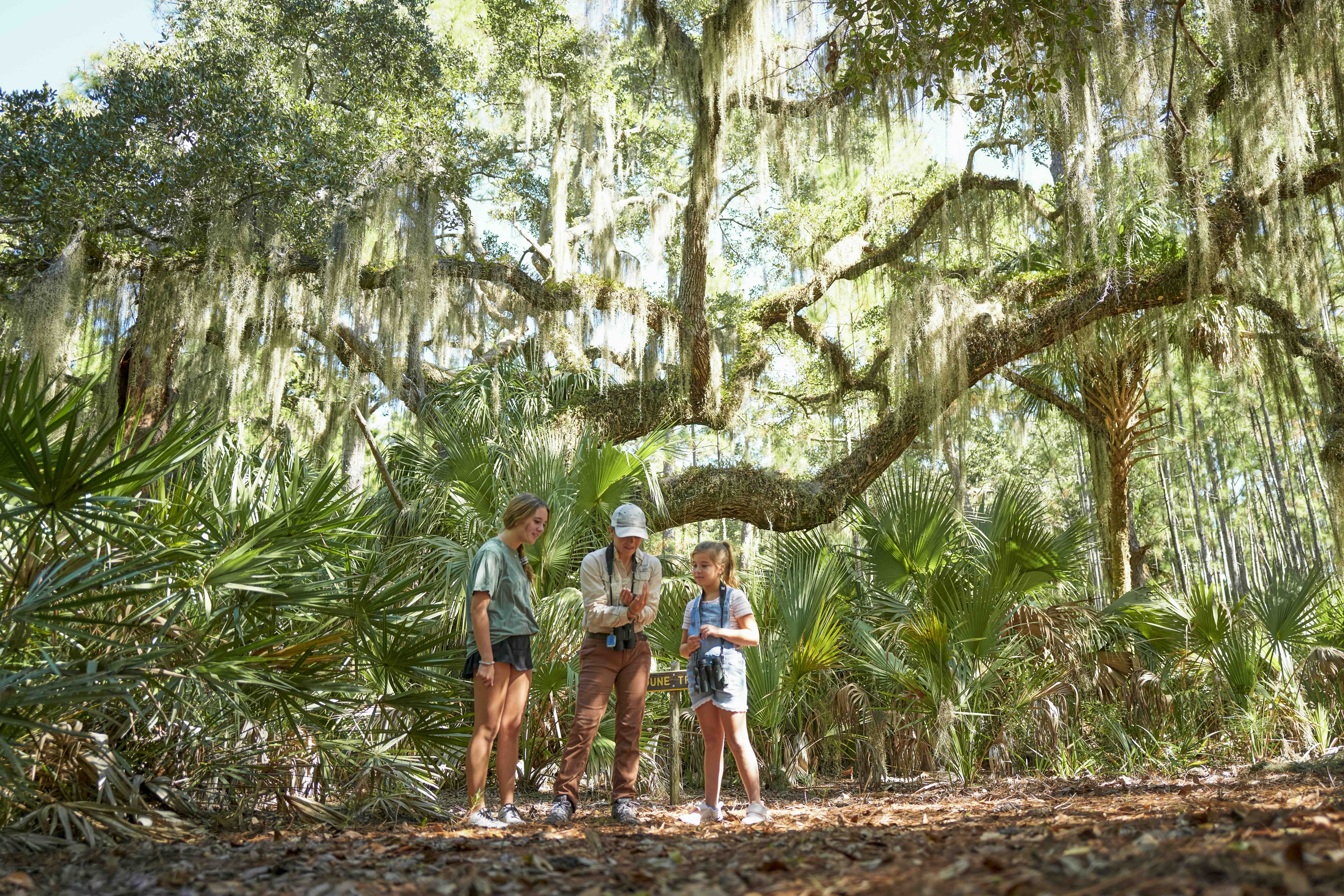 A mother hiking with her two daughters