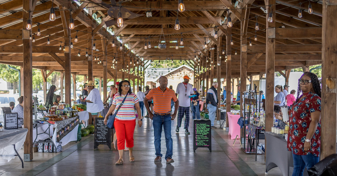 shoppers and vendors under the outdoor pavilion at Market on Madison in Dublin, Georgia