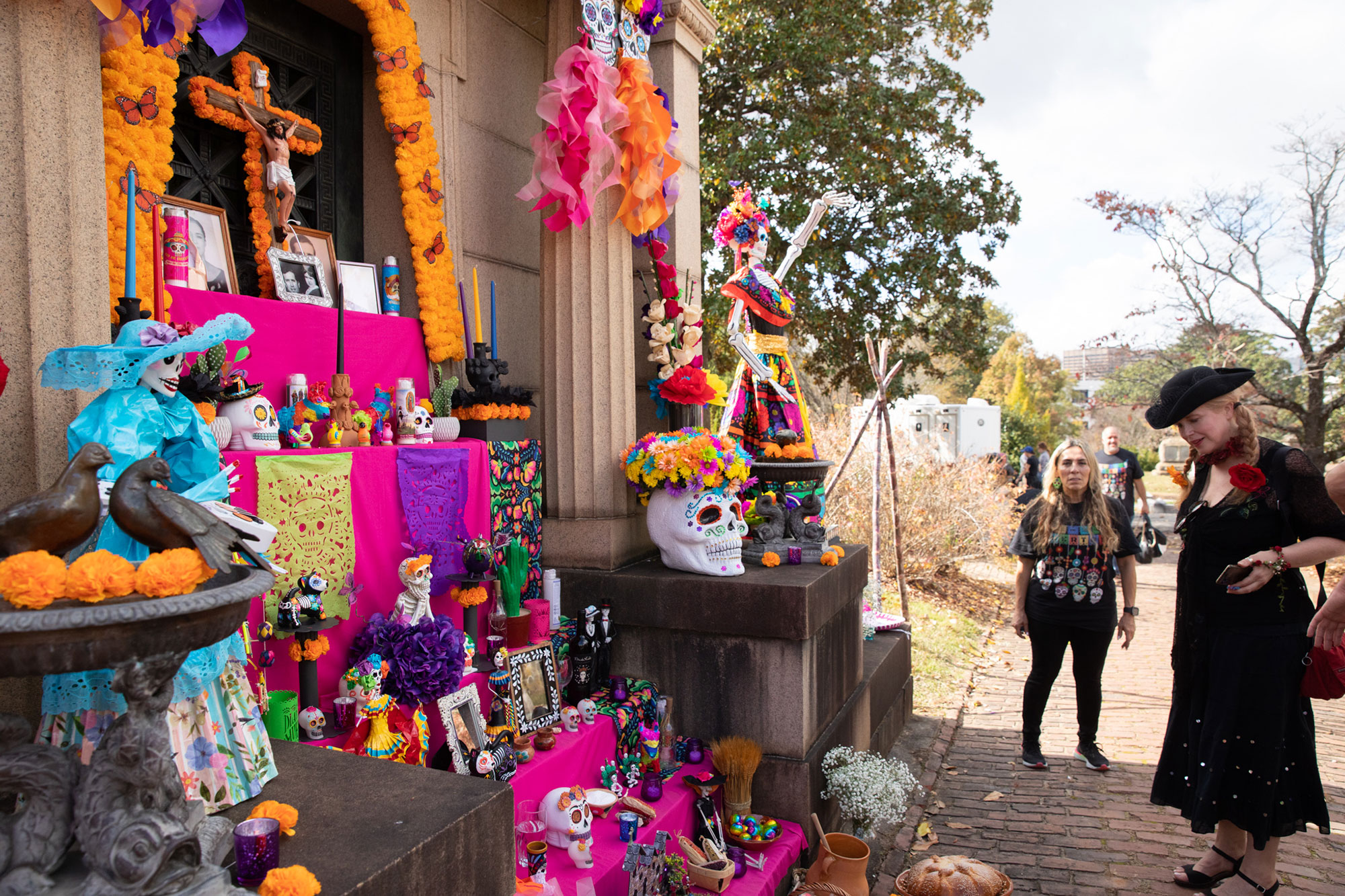Woman admiring an altar for Día de Muertos at Oakland Cemetery in Atlanta, Georgia