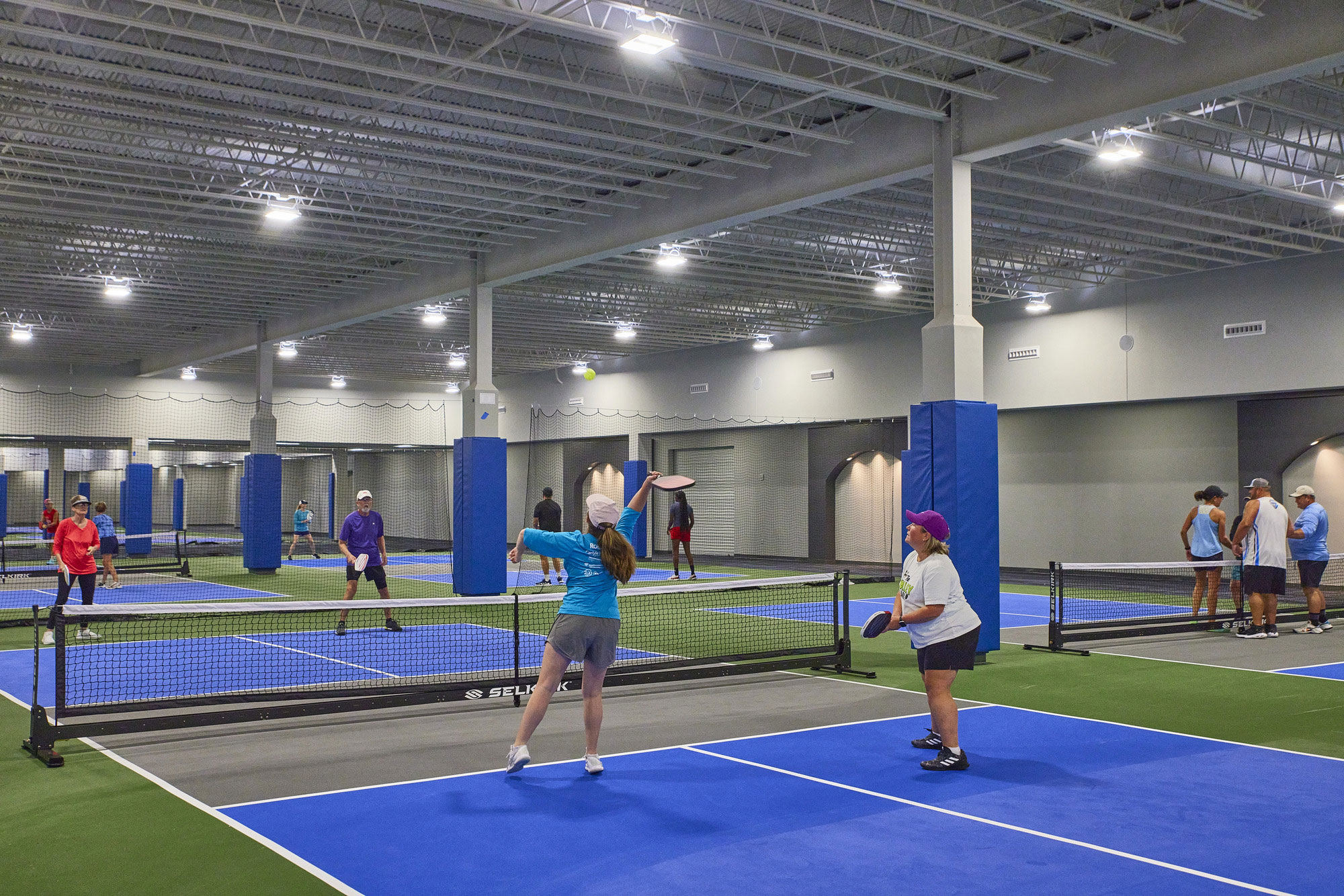 People playing pickleball indoors