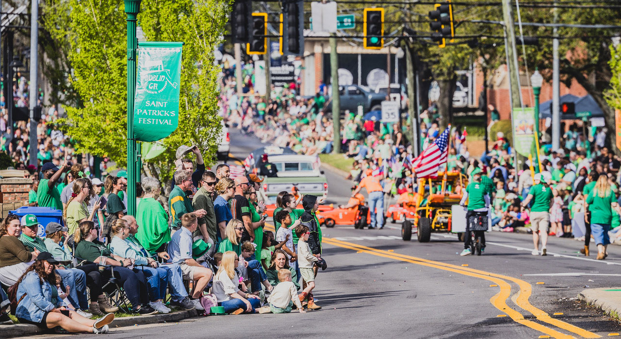 crowds line a street for the St. Patrick's Day parade in Dublin, Georgia