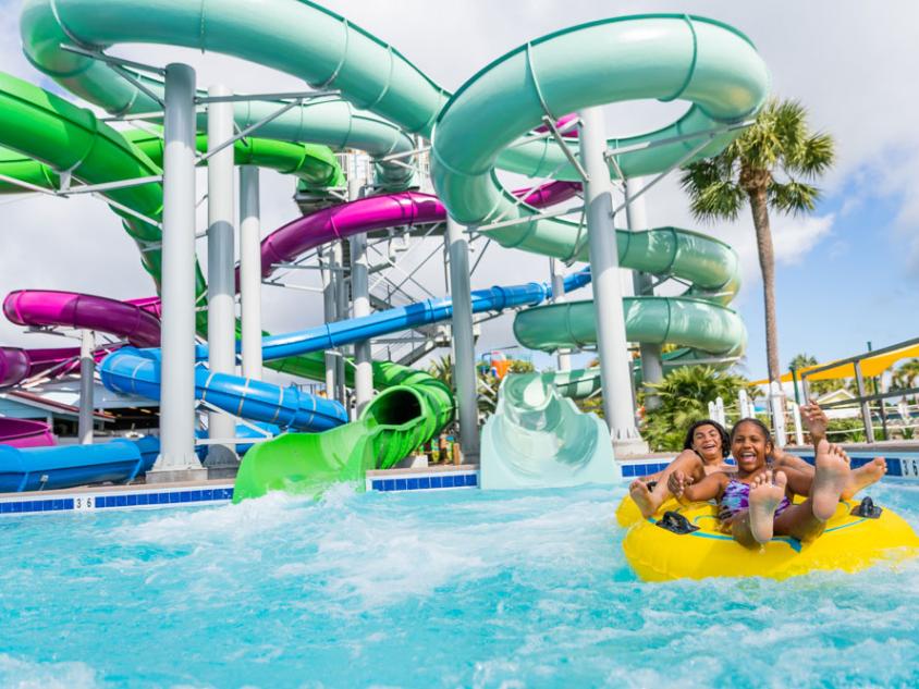 Guest splash around on a large water park slide