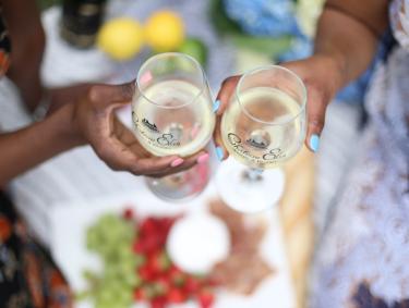 Two women clinking wine glasses together at Chateau Elan in Braselton, Georgia