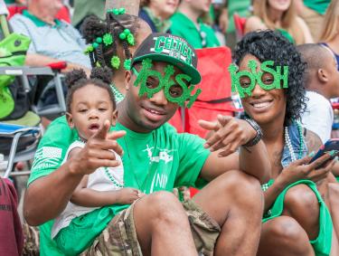 Family watching the St. Patrick's Day parade in Savannah, Georgia