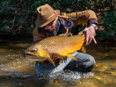 Will Taylor, fishing guide and owner of Fly Shop Co. of Blue Ridge, Georgia, shows off a trout. Photo by Jason Stemple