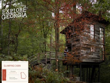 wooden glamping cabin in dark, wooded area
