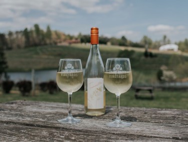 Bottle of white wine and two glasses at Crane Creek Vineyards in Young Harris, Georgia
