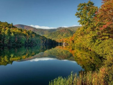 Mountain lake surrounded by colorful fall foliage