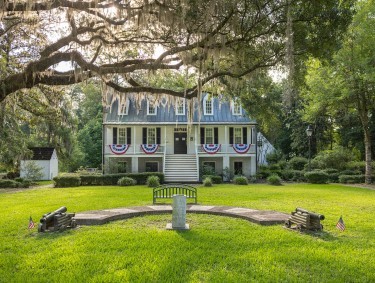Exterior of Midway Museum in Midway, Georgia, decorated with red, white, and blue bunting