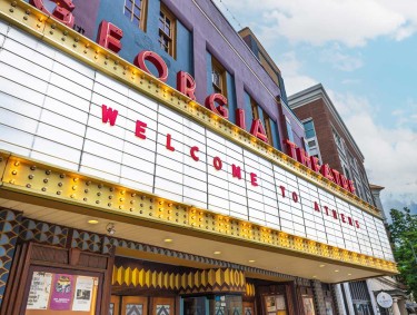 The white marquee of the historical Georgia Theatre with red letters spelling out "Welcome to Athens."