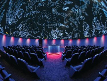 Seats inside a 360-degree planetarium screen