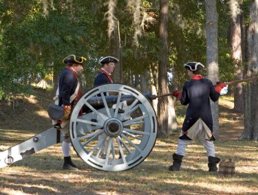 colonial soldier reenactors fire a cannon