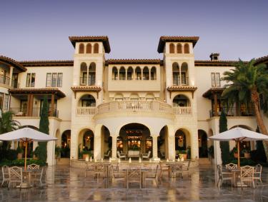 The entrance of a large luxury resort with ivory stonework.