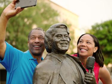 Couple with James Brown statue in Augusta, Georgia