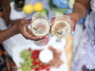 Two women clinking wine glasses together at Chateau Elan in Braselton, Georgia