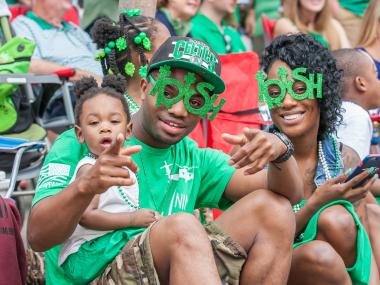 Family watching the St. Patrick's Day parade in Savannah, Georgia