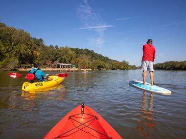 People on the water via kayak or paddle board at the Nantahala Outdoor Center