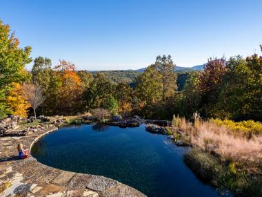 Woman sitting by a pond at Elohee in Sautee Nacoochee, Georgia. Photo by @benjamingalland