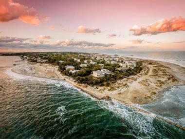 Aerial view of a town on an island surrounded by beaches.
