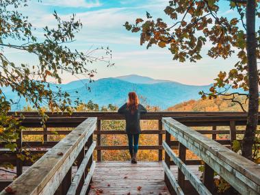 Woman on an overlook at Black Rock Mountain State Park in Mountain City, Georgia. Photo by @jake.teki