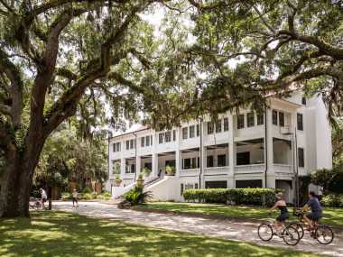 Cyclists riding in front of Greyfield Inn on Cumberland Island, Georgia