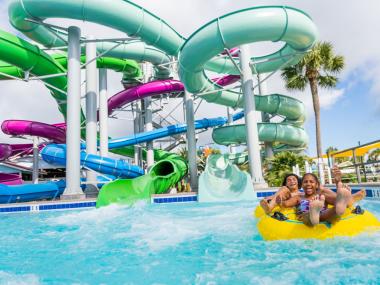 Guest splash around on a large water park slide