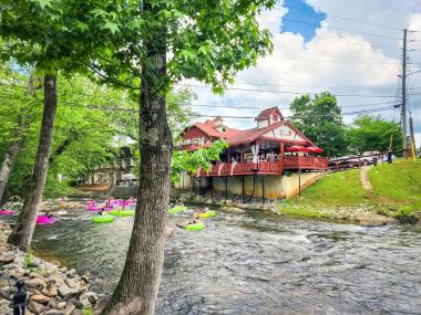 People on tubes float down a river in Helen, Georgia
