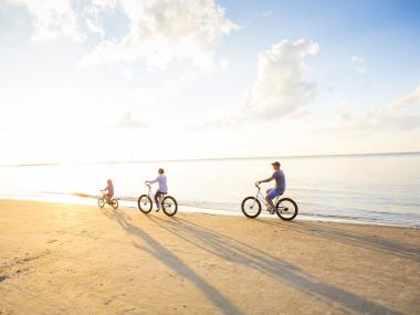 Family biking on the beach on Jekyll Island, Georgia