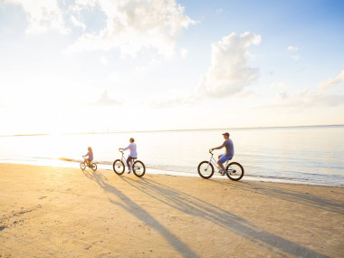 Family biking on the beach on Jekyll Island, Georgia
