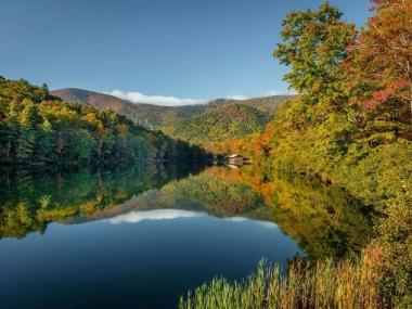 Mountain lake surrounded by colorful fall foliage